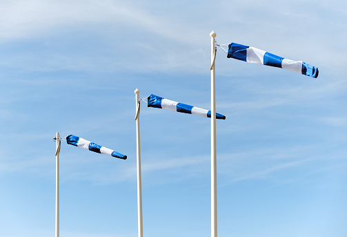 Three windsocks showing wind direction and speed at airport,  minimalist close up picture