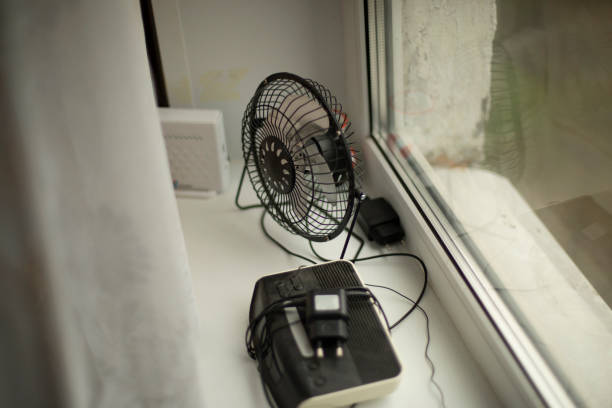 istock Fan is on window. Items lie on windowsill. Electrical appliances at home. 1421851739