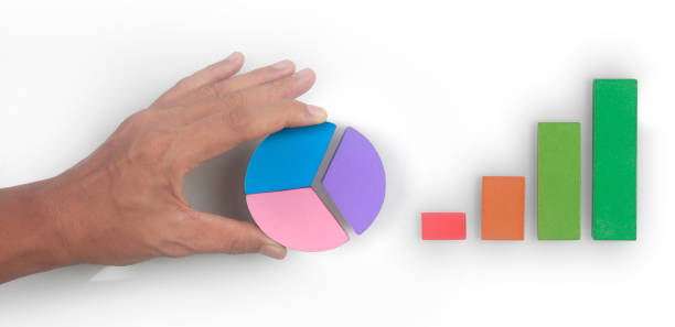 istock Business connecting piece of multi colored pie chart in  hand 1421853295