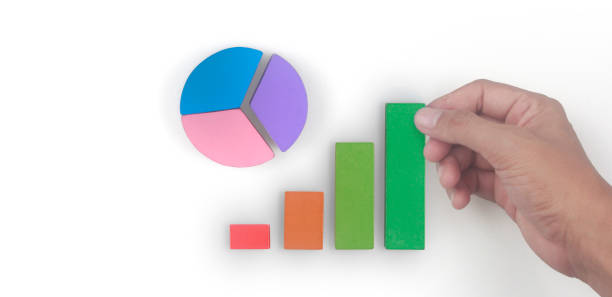 istock Business connecting piece of multi colored pie chart in  hand 1421853300