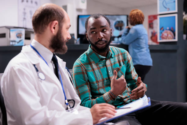 istock General practitioner talking to male patient in waiting room 1421853376
