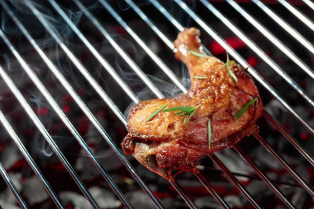 istock Chicken with rosemary on a grill. 1421858975