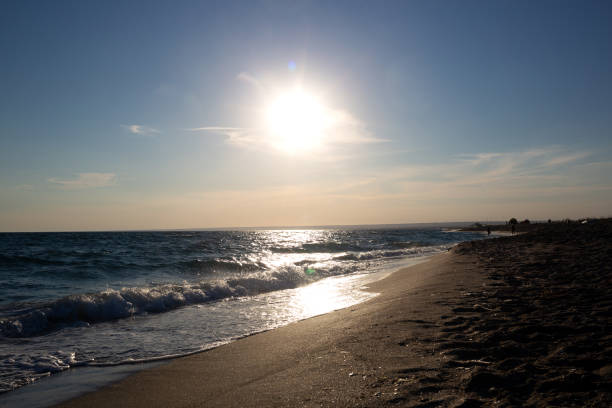 istock beautiful natural sandy beach with waves at sunset 1421861354