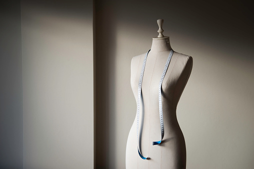 Close-up of female tailor's mannequin with measuring tape.