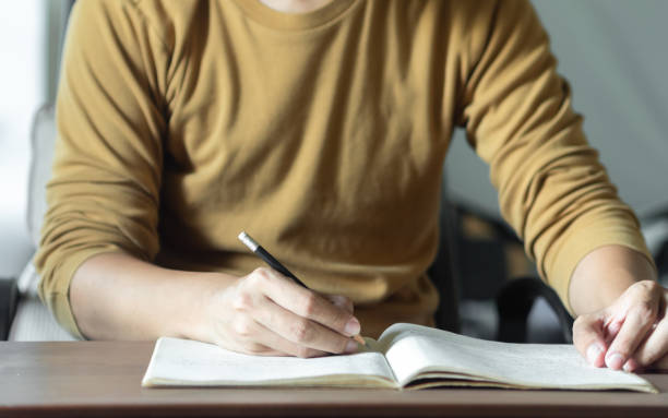 istock Asian man's hand studying and education in room school 1421863581