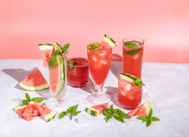 istock Different elegant glasses with watermelon cocktail. Splash, splatter, water drops on the pink background 1421867236