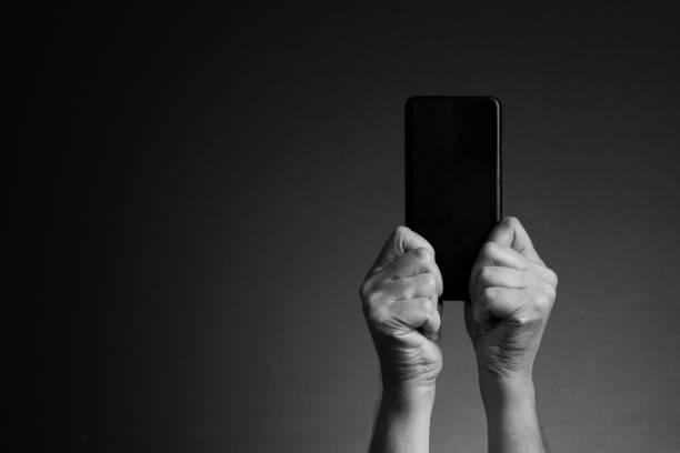 istock Hands holding smart phone and texting, rear view and copy space 1421870072