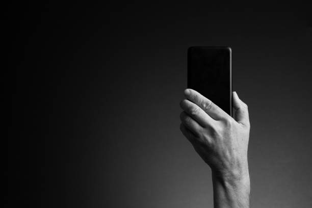 istock Hand holding smart phone, rear view and copy space 1421870085
