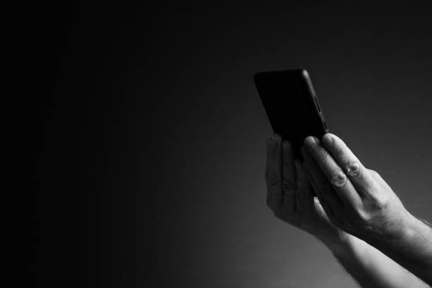 istock Hands holding smart phone, side view and copy space 1421870184