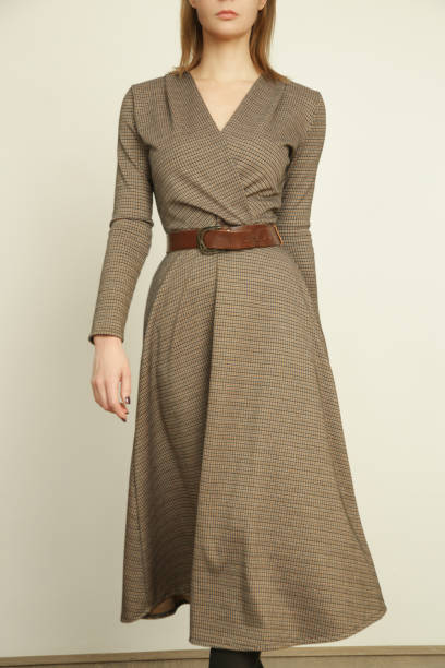 Serie of studio photos of young female model in brown tweed dress, autumn winter fashion collection. stock photo