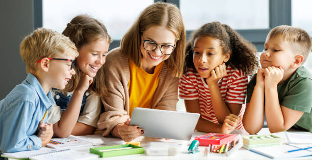 istock Teacher and students watching video together 1421872583