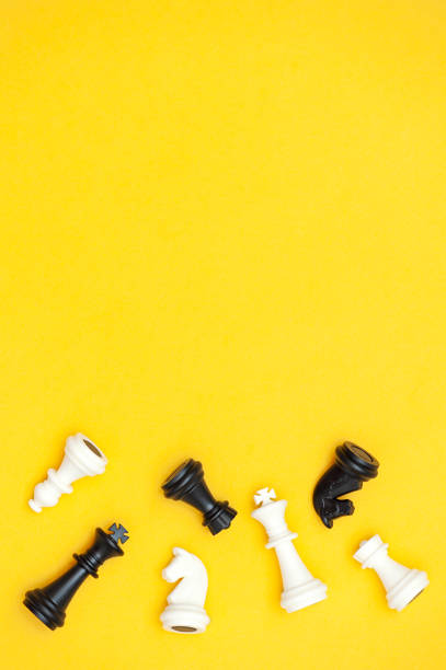 istock Flat lay of chess pieces on a yellow background, copy space. vertical photo 1421875475