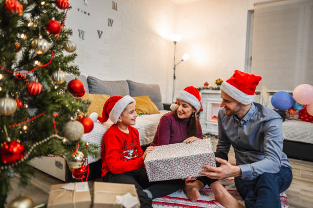 istock Parents and child with Christmas presents 1421876160