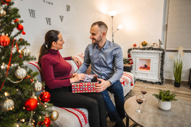 istock During Christmas Eve, the wife opens a gift from her husband 1421876580