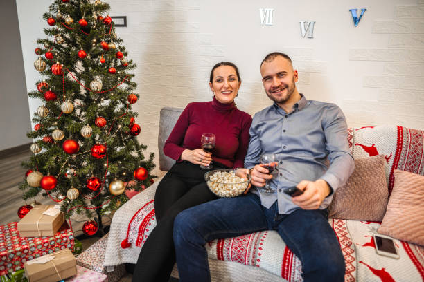 istock Happy couple enjoying on sofa, watching TV 1421876932