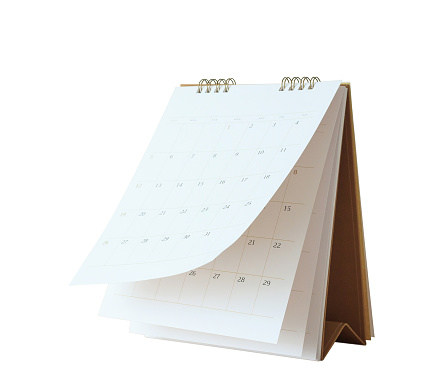 Thumbtack pins on a calendar.