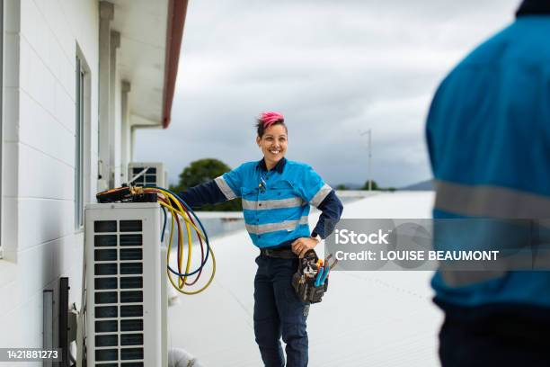 Day In The Life Of A Female Tradie And Her Coworker Stock Photo - Download Image Now