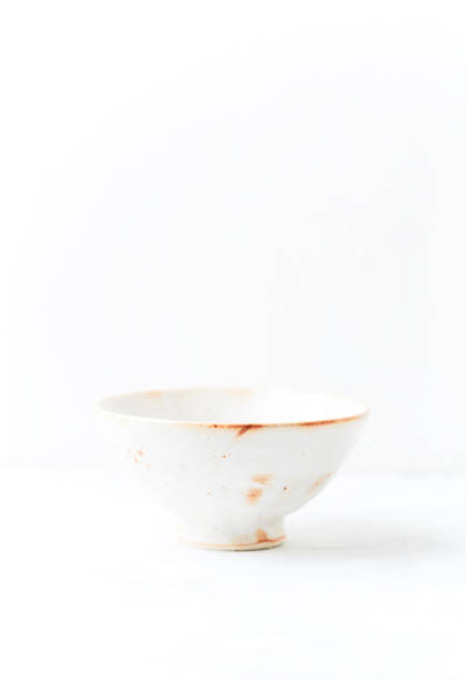 istock Traditional ceramic bowl on bright  background. Soft focus. Copy space. 1421882228