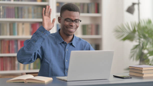 istock Young African Man Talking on Video Call on Laptop in Office 1421882998