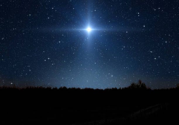 étoile brillante, ciel étoilé et silhouette de forêt. l’étoile indique la nativité de jésus-christ dans le ciel étoilé. - crèche de noël photos et images de collection