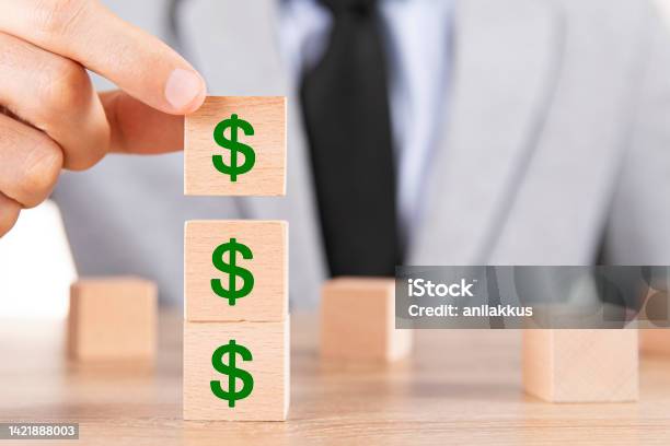 Finance And Economy Concept With Wooden Cubes Stock Photo - Download Image Now - Dollar Sign, Savings, Green Color