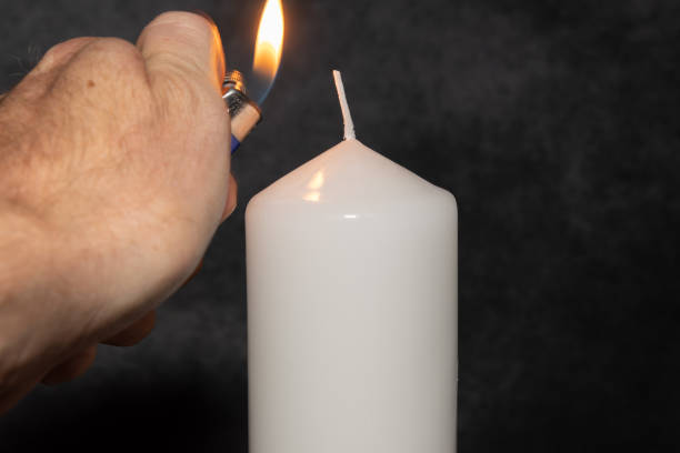 istock Candle light in the darkness 1421888695