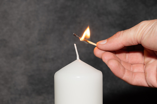 Vaduz, Liechtenstein, September 6, 2022 Lighting on a candle with a small fire