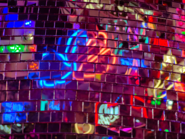 istock Neon lights reflected in metallic disco ball abstract background 1421889597