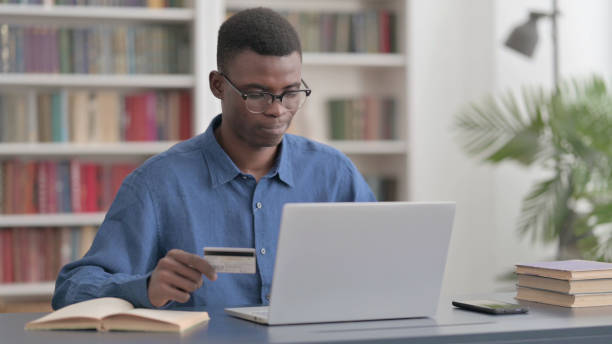 istock Young African Man Having Online Payment Problems on Laptop 1421889895