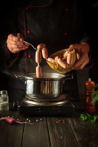 For a delicious breakfast need to cook delicious milk sausages. Chef in the kitchen during work