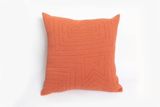 istock Modern orange pillow isolated on white. 1421894107