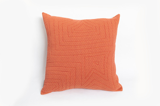 Modern orange pillow isolated on white background.