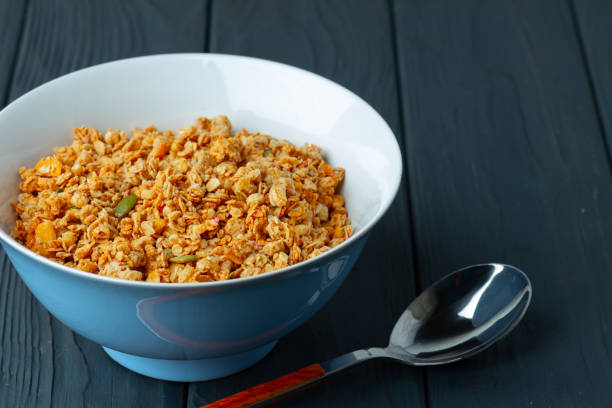 istock Bowl with granola on wooden table close up 1421896592