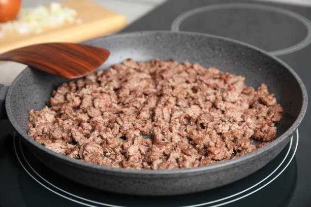 istock Frying minced meat in pan on induction stove, closeup 1421900155
