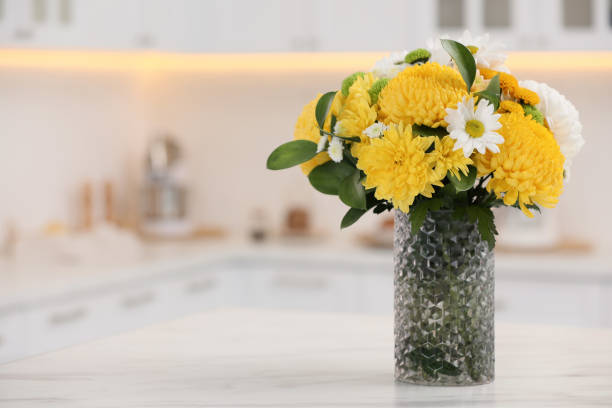 istock Bouquet of beautiful chrysanthemum flowers on table in kitchen, space for text 1421902099