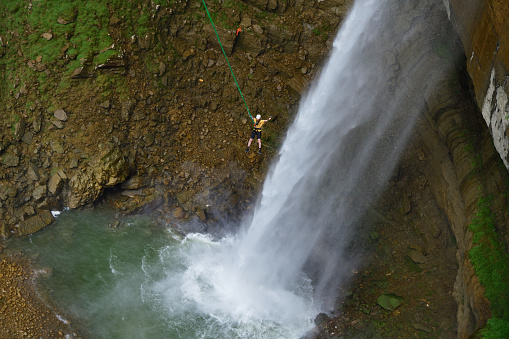 Dagestan, Russia - 21 July, 2022: Jumper shown after a successful jump to the waterfall. Hunzah. Tobot Waterfall. Canyon Of Khunzakh, Caucasus mountains.