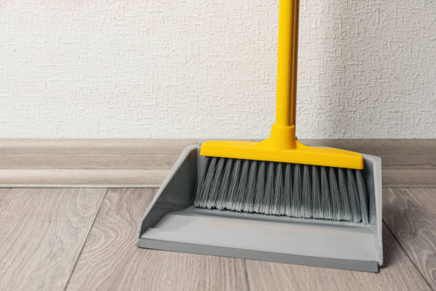 istock Plastic broom with dustpan on wooden floor indoors 1421903460