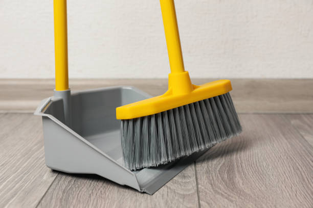 istock Plastic broom with dustpan on wooden floor indoors 1421903474