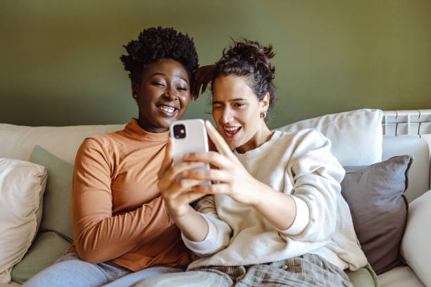 istock Female friends taking selfie at home 1421903565