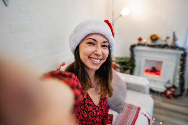 istock Young woman taking a selfie at Christmas night 1421903606