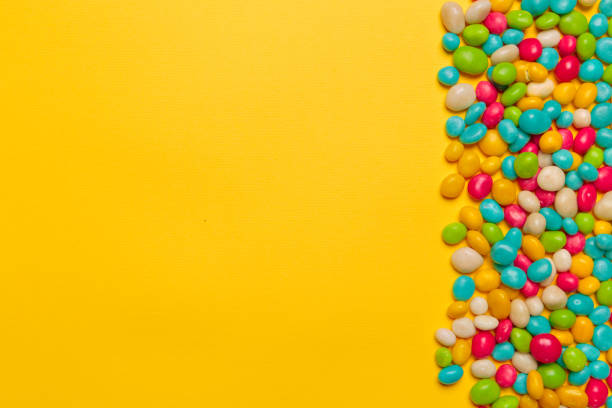istock colored candies on yellow background 1421903979