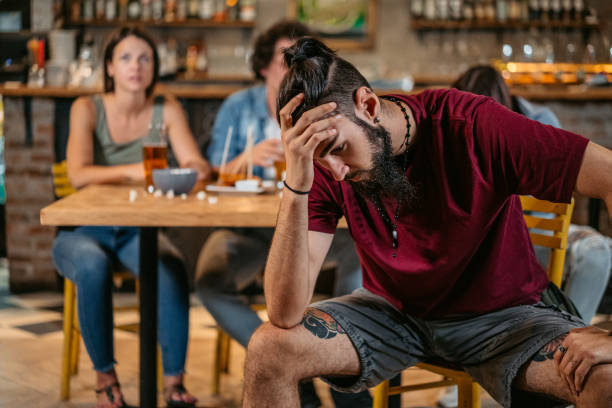 istock Young Man Disappointed While Watching A Sports Game In A Bar 1421904896