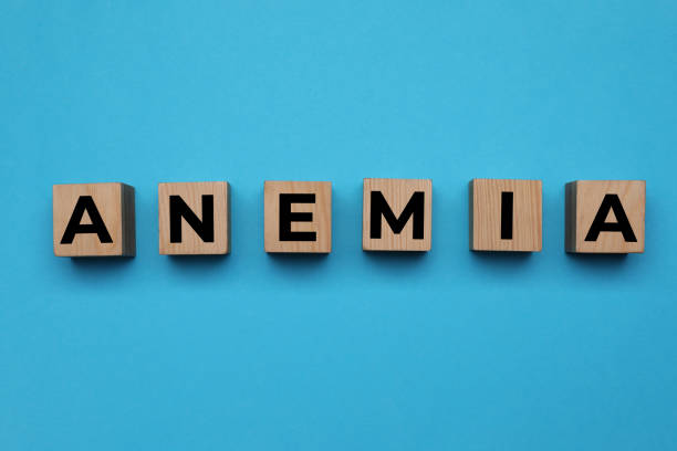 istock Wooden cubes with word Anemia on light blue background, flat lay 1421906244