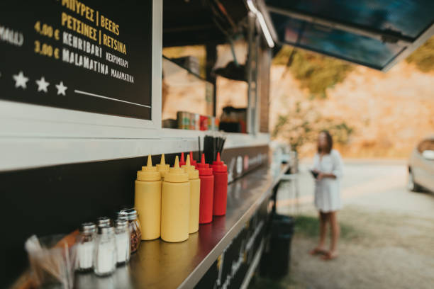 Mayo and ketchup bottles at the food truck window Close-up of mayo and ketchup bottles at the food truck window on a sunny summer day ketchup and mustard bottles stock pictures, royalty-free photos & images