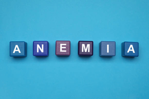istock Wooden cubes with word Anemia on light blue background, flat lay 1421906408