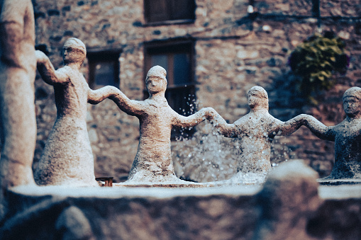Figures Dancing Around Fountain