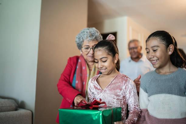 istock Child holding christmas present at home 1421911096