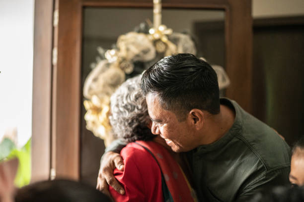 Son greeting mother on christmas at home
