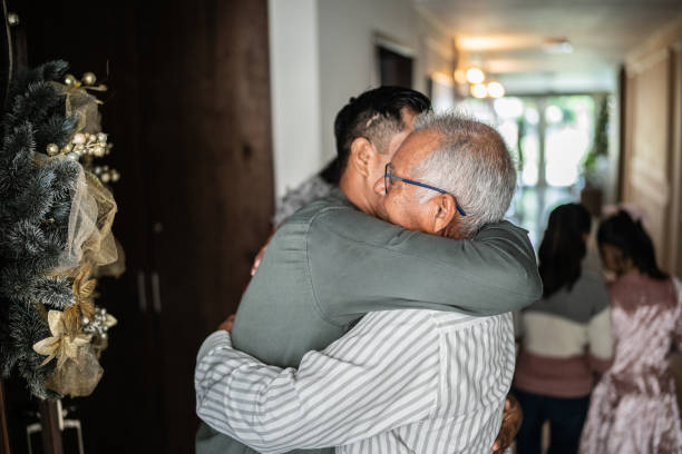 istock Son greeting father on christmas at home 1421911693