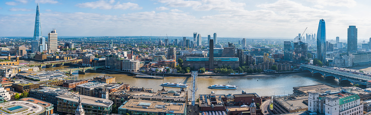 Aerial panorama along the River Thames, past the iconic spire of The Shard to the skyscrapers of the South Bank.